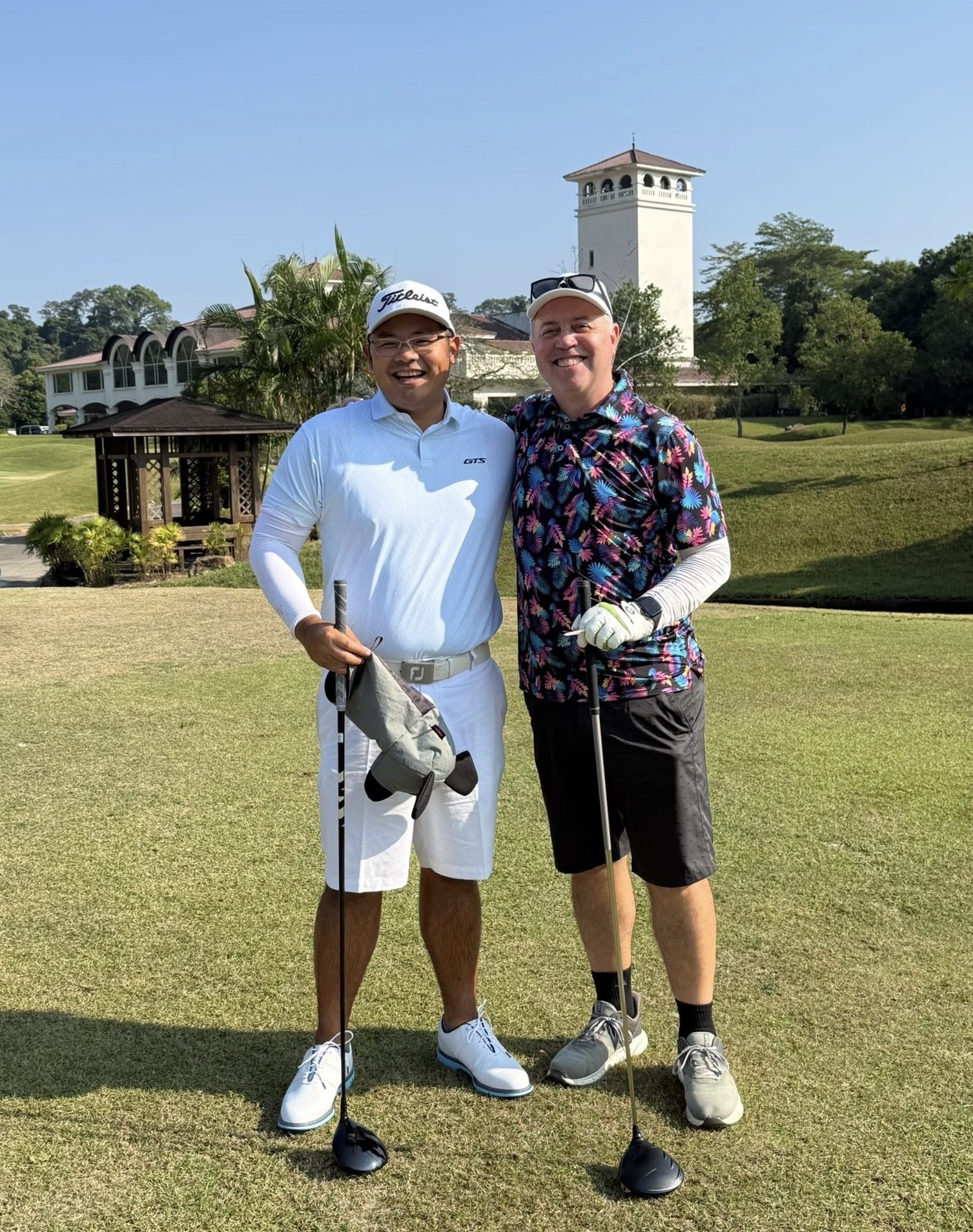 Two IGST members by a clubhouse tower